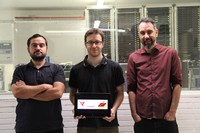 From left to right: researchers Eduard Alarcón, Sergi Abadal—holding a tablet in his hands showing the logo of the project and a simulation that is being worked on—and Albert Cabellos